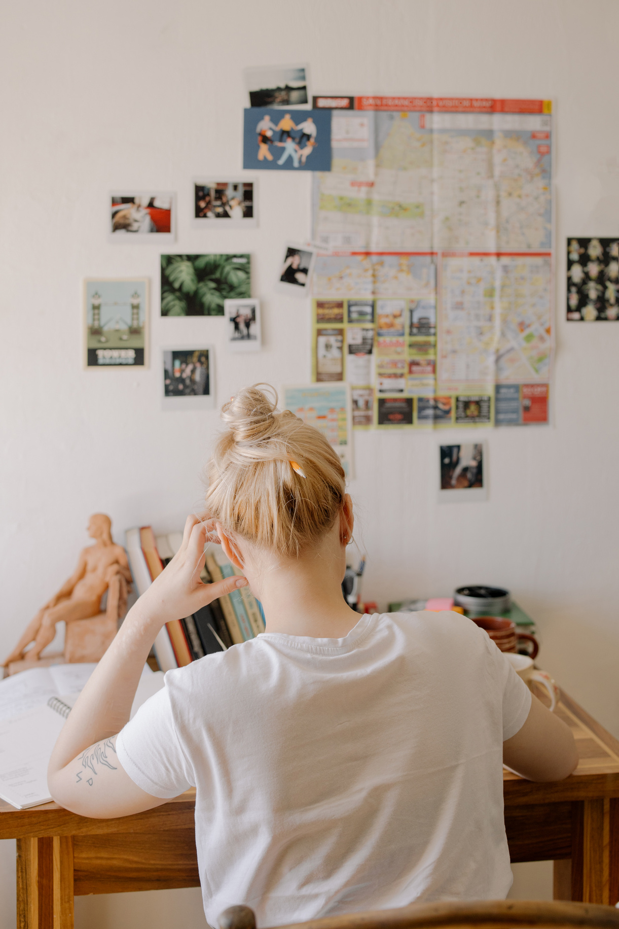 Woman in White Crew Neck T-shirt Sitting on Bed